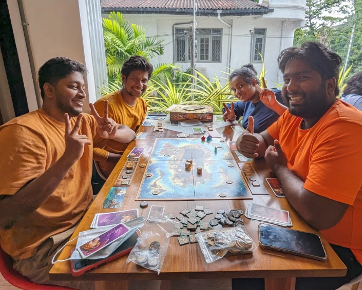 A picture of four people playing a board game