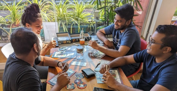 four board gamers play a game
