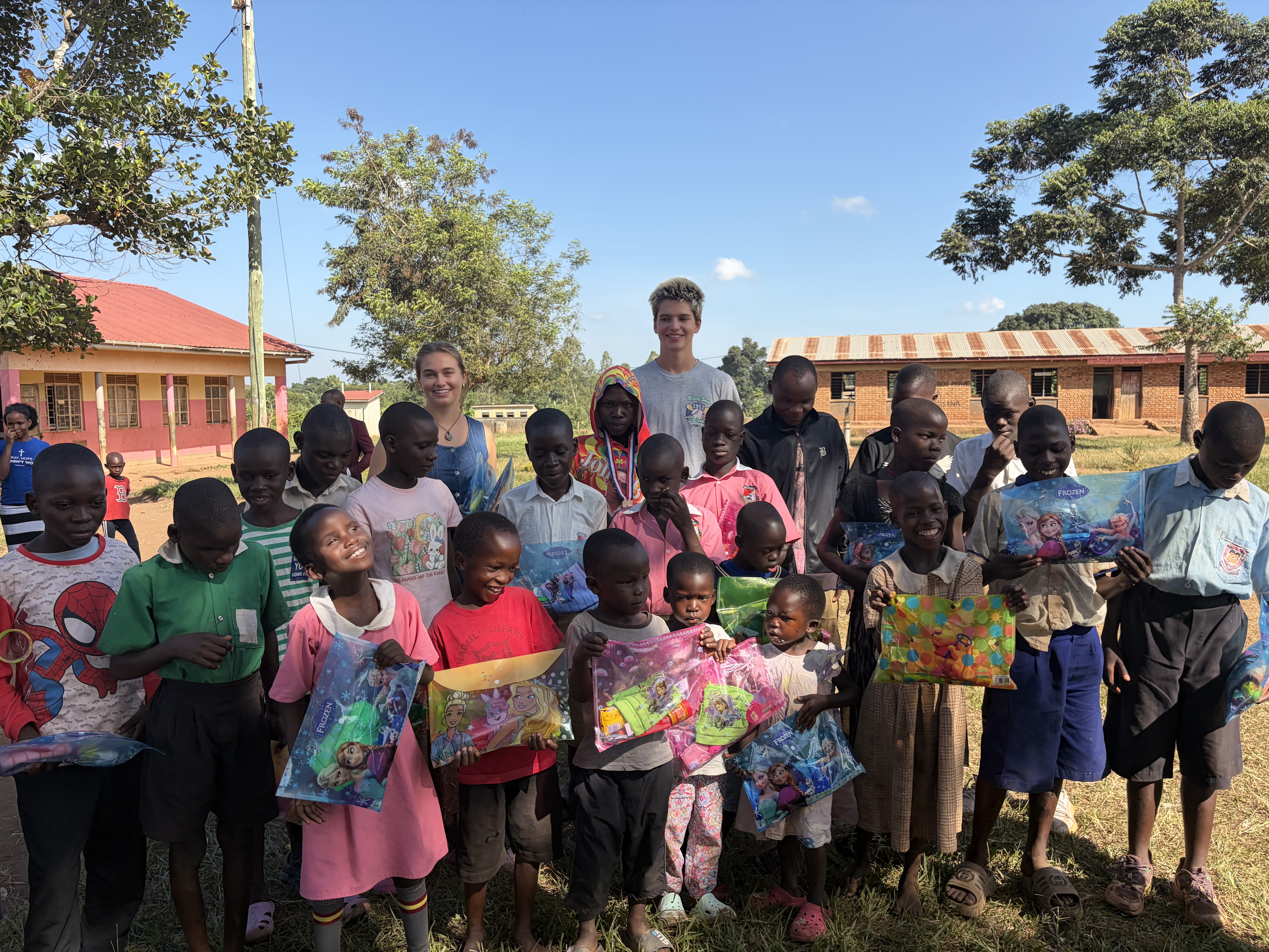 Group photo of children holding their hygiene kits, smiling